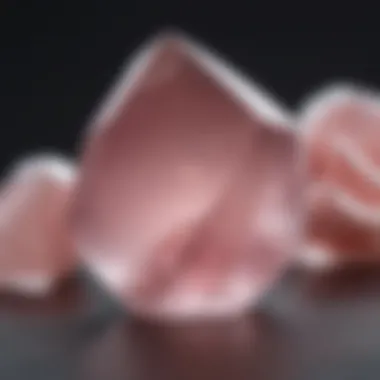 A close-up view of a polished rose quartz crystal showcasing its translucent pink hues