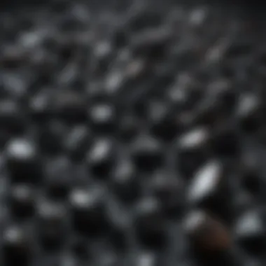 An array of different black crystals arranged artistically on a textured surface