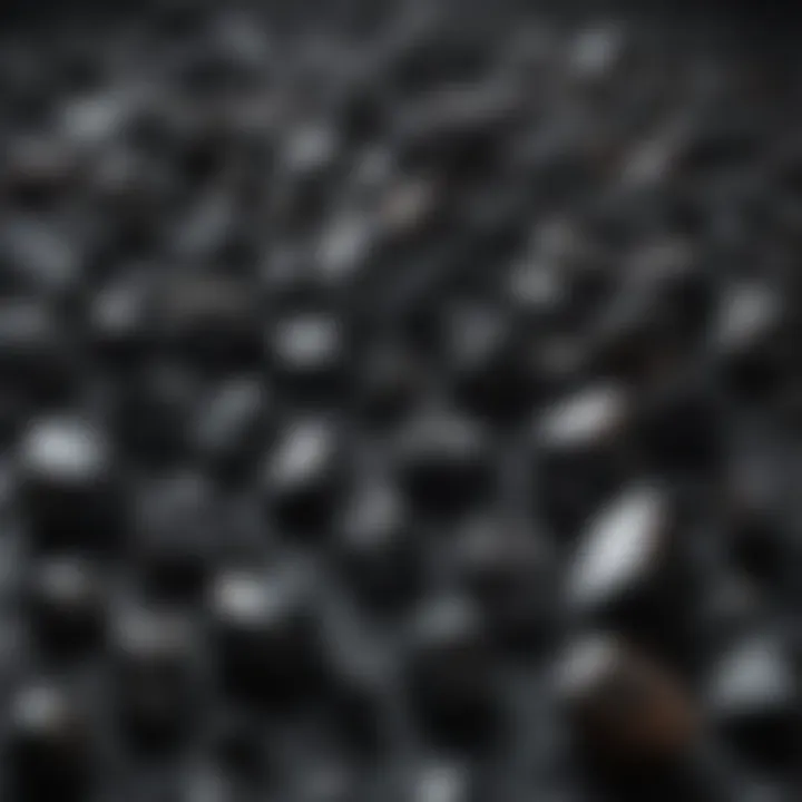 An array of different black crystals arranged artistically on a textured surface