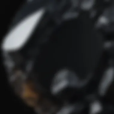 Rough black onyx stone with unique patterns and textures displayed against a dark background