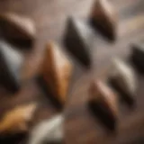 A collection of unique arrowheads displayed on a wooden surface.