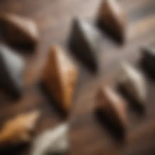 A collection of unique arrowheads displayed on a wooden surface.