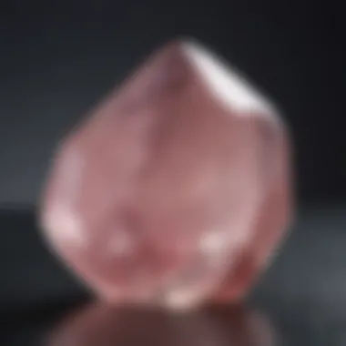 Close-up view of a polished rose quartz crystal showcasing its unique color and clarity